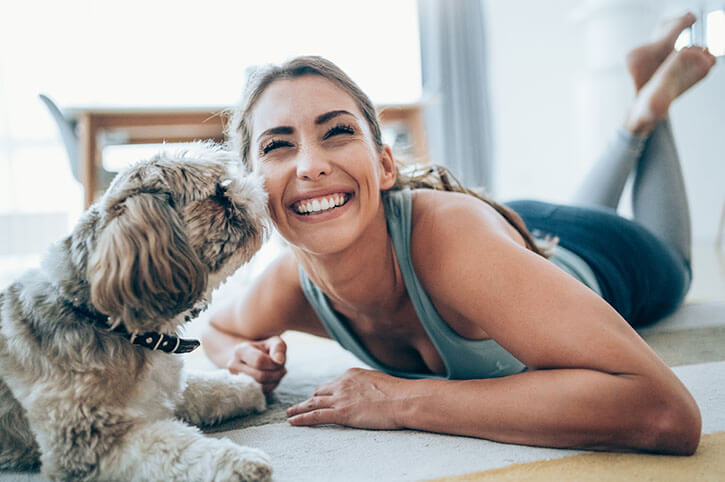 Female vet smiling at a puppy